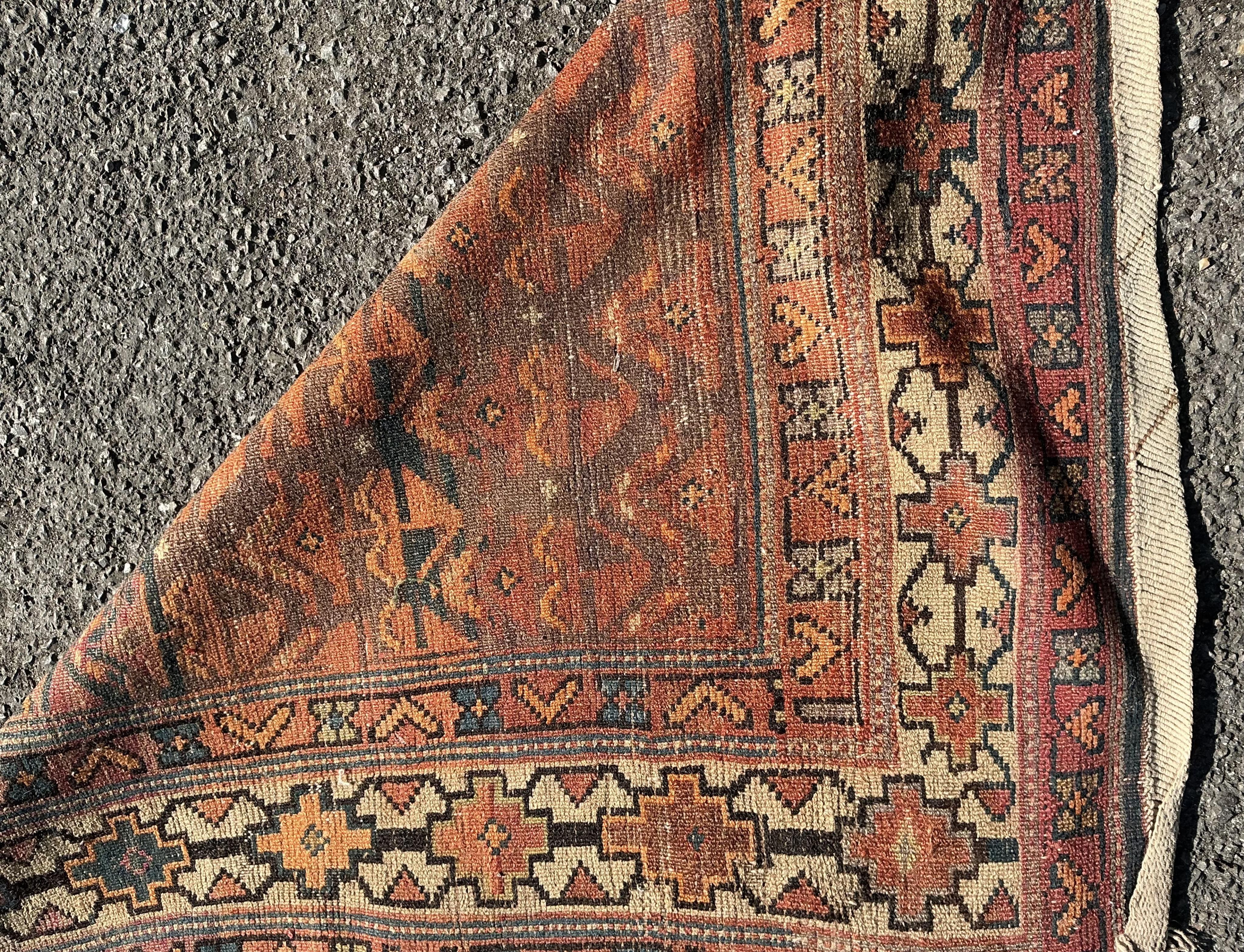 An antique Caucasian blue ground runner, heavily worn and faded, 342 x 96cm
